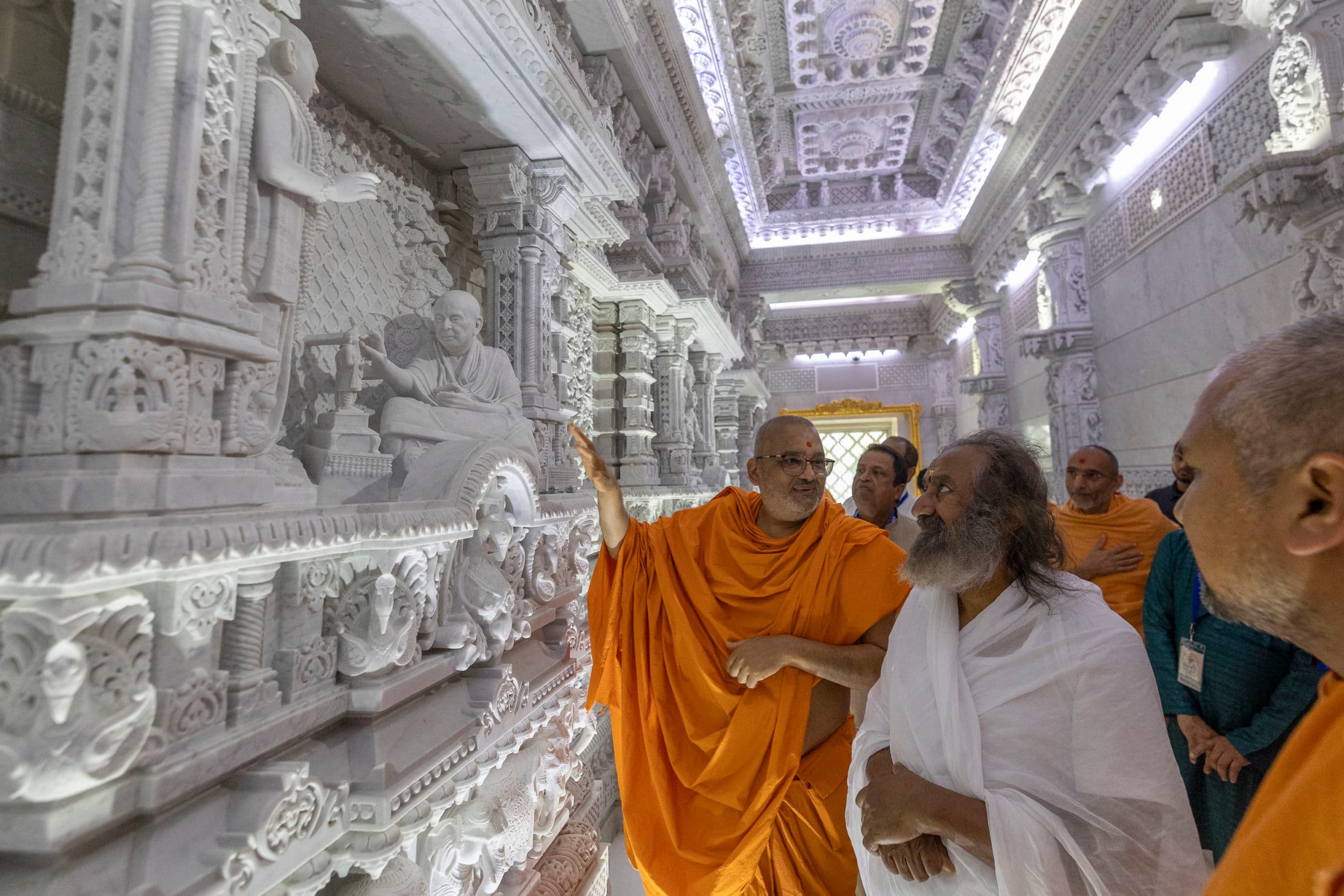 Gurudev Sri Sri Ravishankar receives a tour of the BAPS Swaminarayan Akshardham complex.